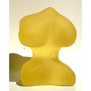 A yellow piece of glass sitting on top of a table.